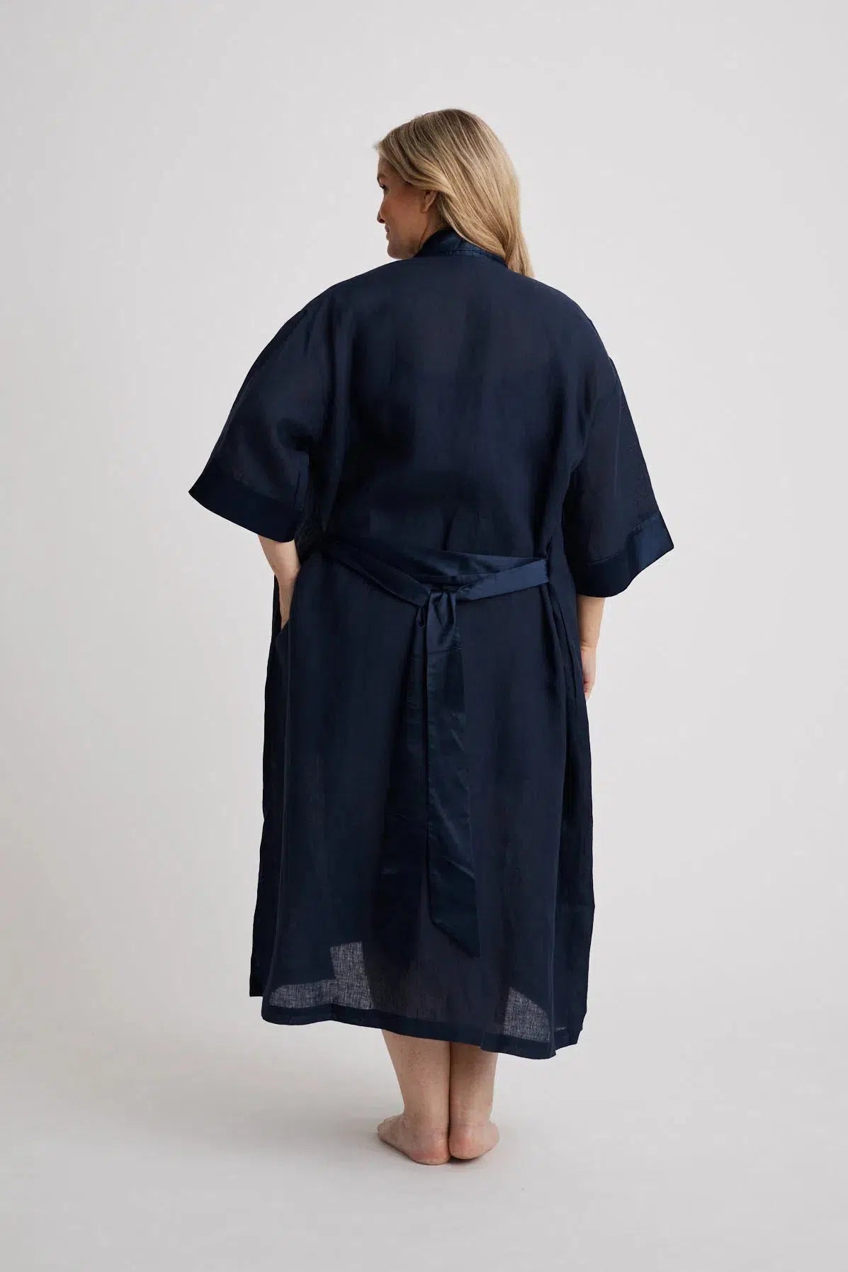 Woman wearing the long Anne linen robe in navy, lightweight cover-up inclusive sizes XS–4XL