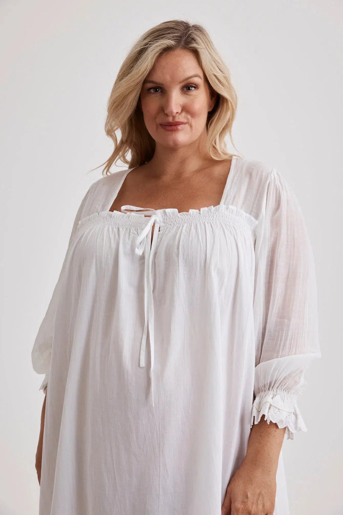 Woman wearing Barbara cotton long-sleeve nightgown in White, inclusive sizes XS–4XL, soft and comfortable for sleep