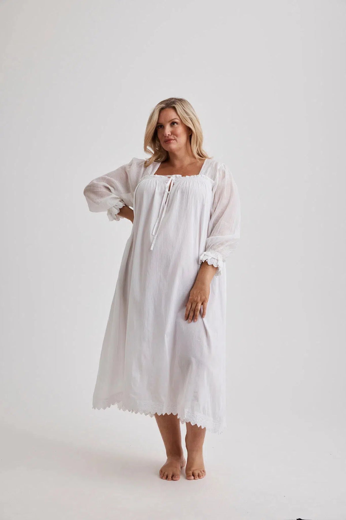Woman wearing Barbara cotton long-sleeve nightgown in White, inclusive sizes XS–4XL, soft and comfortable for sleep