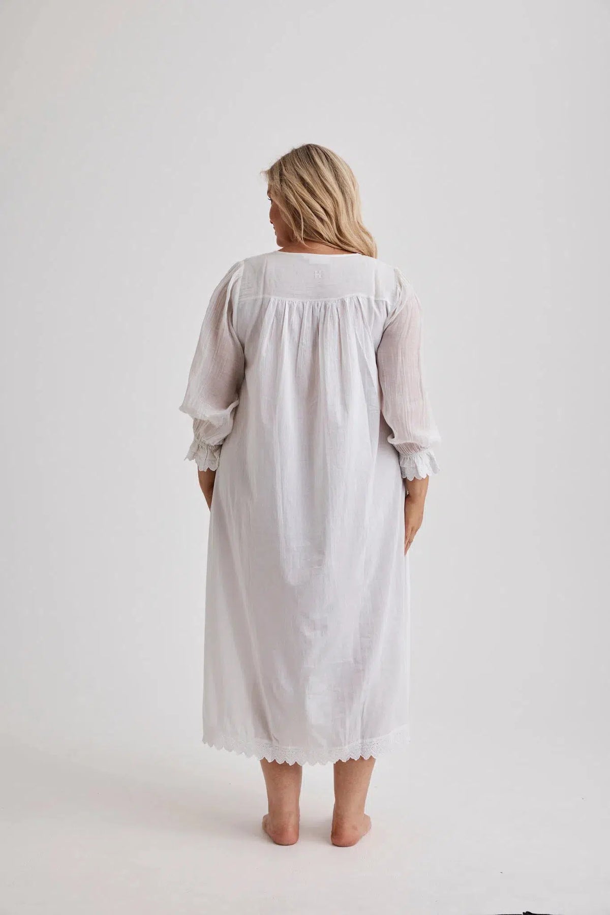 Woman wearing Barbara cotton long-sleeve nightgown in White, inclusive sizes XS–4XL, soft and comfortable for sleep