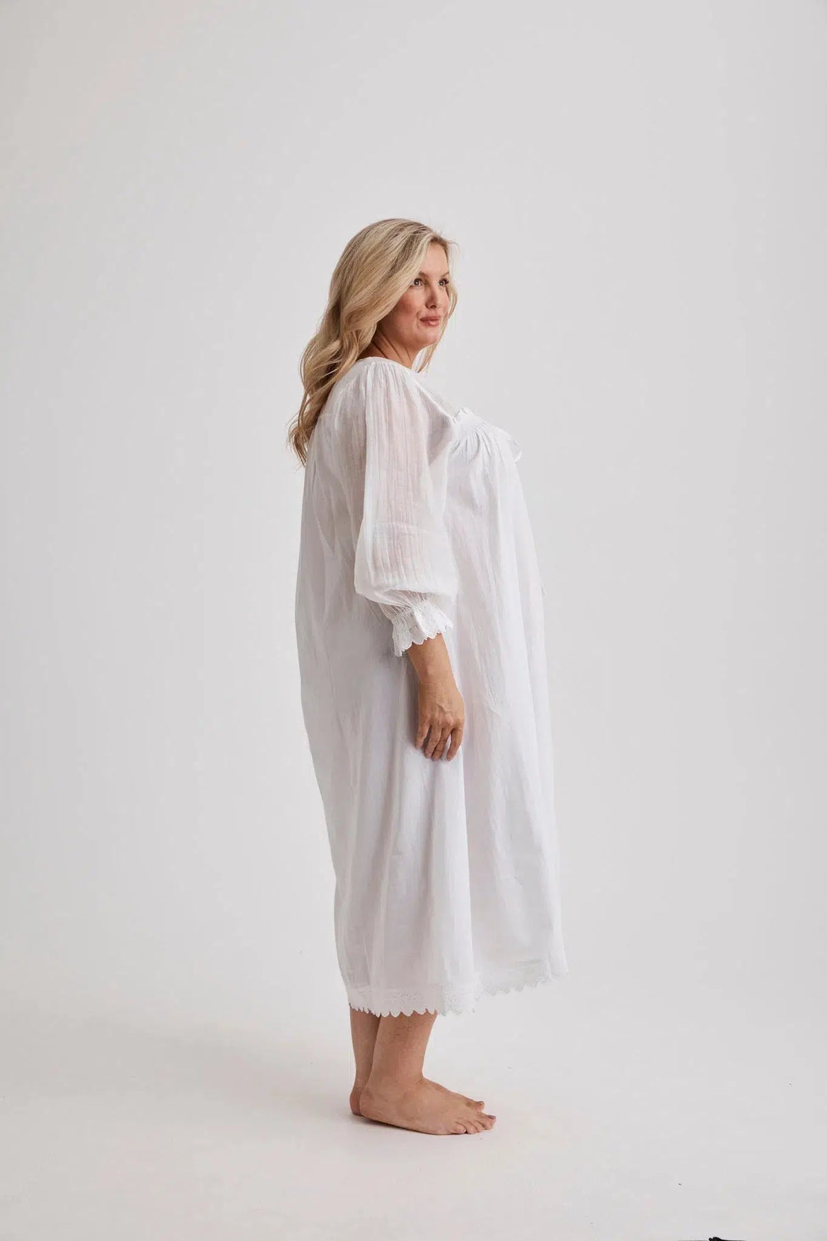 Woman wearing Barbara cotton long-sleeve nightgown in White, inclusive sizes XS–4XL, soft and comfortable for sleep
