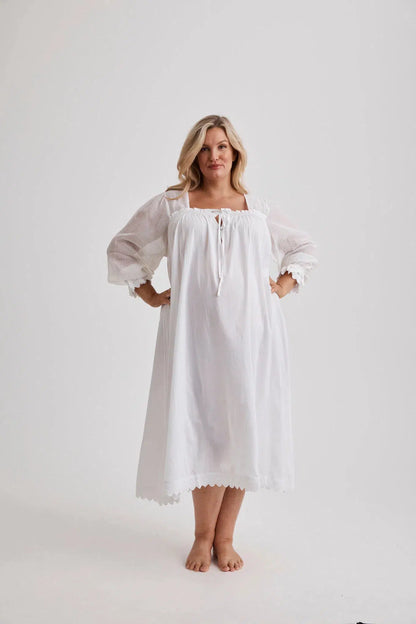 Woman wearing Barbara cotton long-sleeve nightgown in White, inclusive sizes XS–4XL, soft and comfortable for sleep
