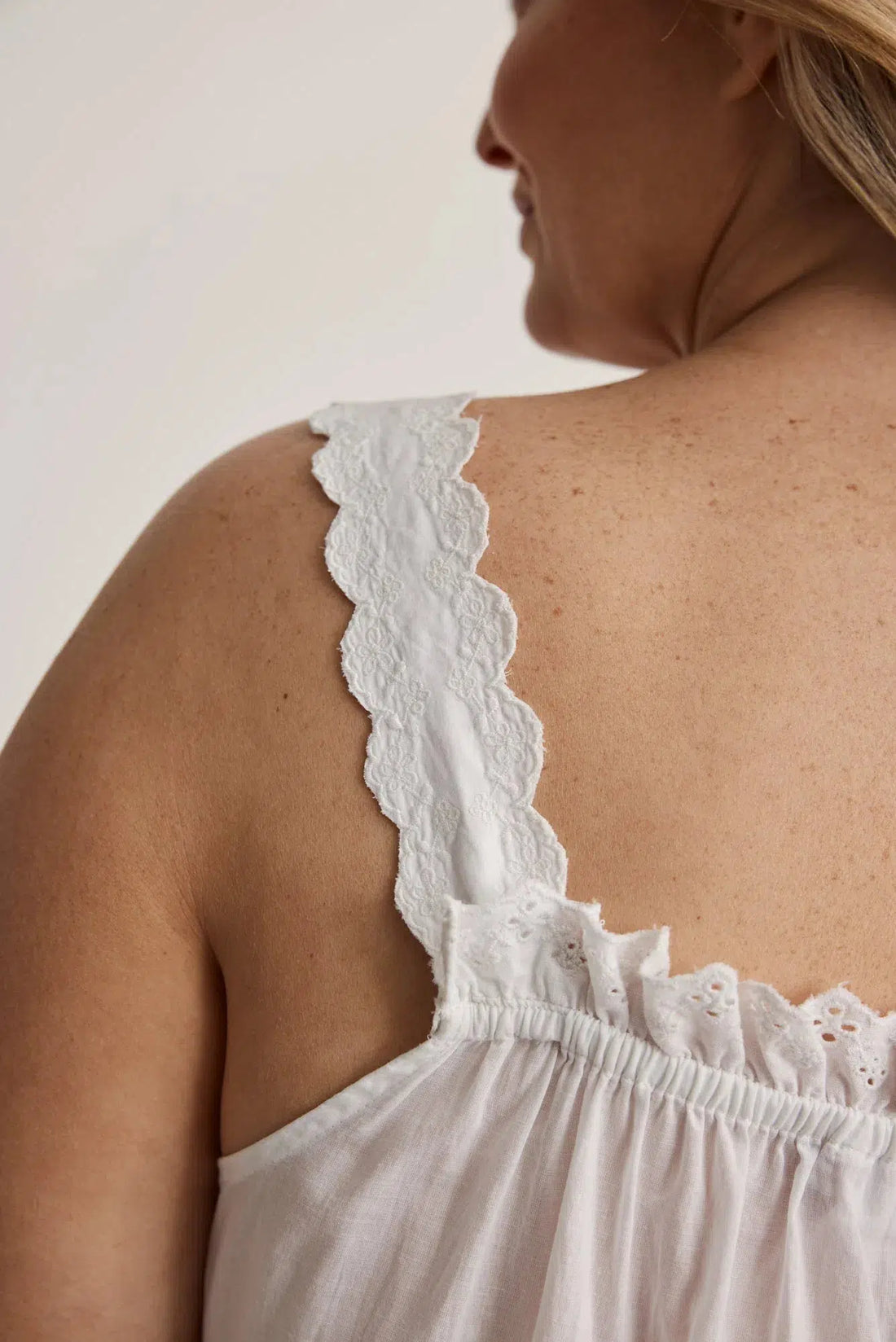 Woman wearing Lauren cotton button-front nightgown in white, inclusive sizes XS–4XL, ideal for hospital stays and recovery